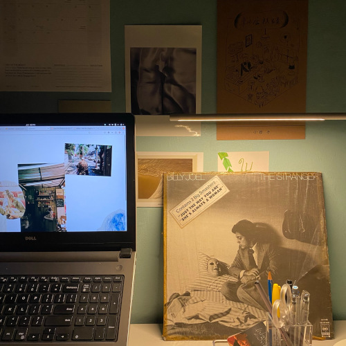 A photo of my desk setup. The Billy Joel vinyl record I bought from a laundry shop nearby.